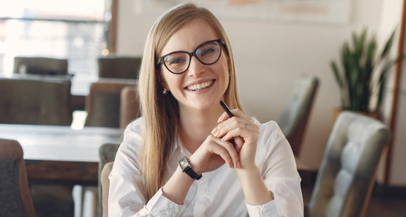 cheerful-young-businesswoman-in-eyeglasses-during-remote-3874619 1